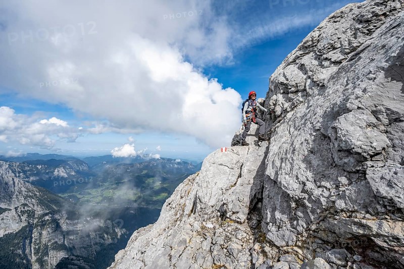 Mountaineer on a narrow rocky mountain path