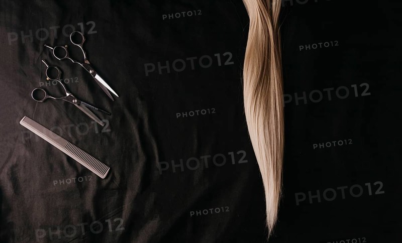Natural hair of different colors with scissors and comb. concept of hair care and hairdressing services