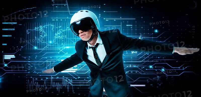 Portrait of a man in a suit and helmet. He shows that he is flying against the background of a futuristic hologram. Business concept. Internet technologies.