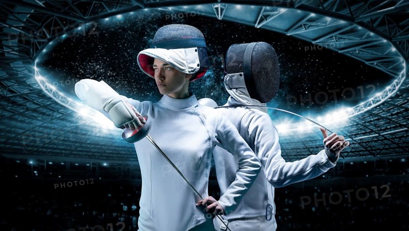 Portrait of two fencers against the backdrop of a sports arena. The concept of fencing. Duel.
