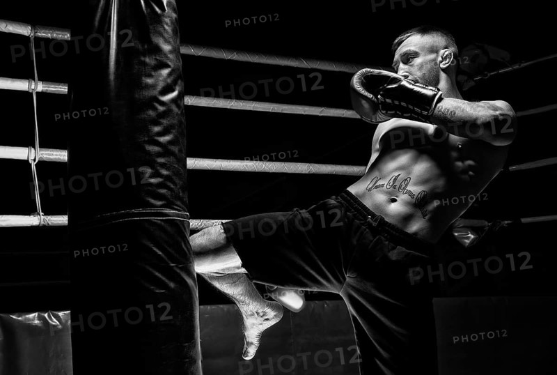 Kickboxer hits the bag with his knee. Training a professional athlete. The concept of mma