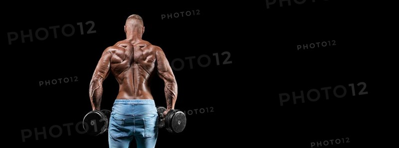 Isolated muscular man on a black background. Bodybuilding and fitness concept. Panorama.