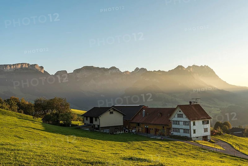 Lonely farmhouse in the Appenzell Alps in front of the Alpstein mountains with Saentis