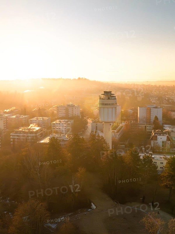 Golden dawn with a view of a municipal water tower