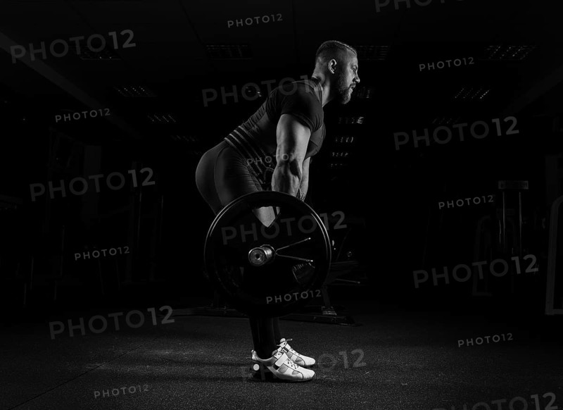 The weightlifter performs an exercise called deadlift. He fixed the weight
