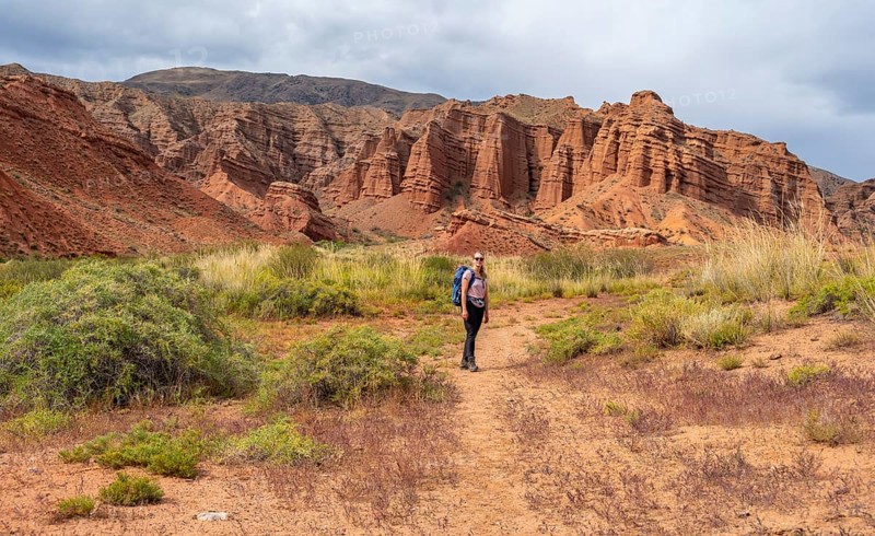 Climber in a canyon with a dry stream bed