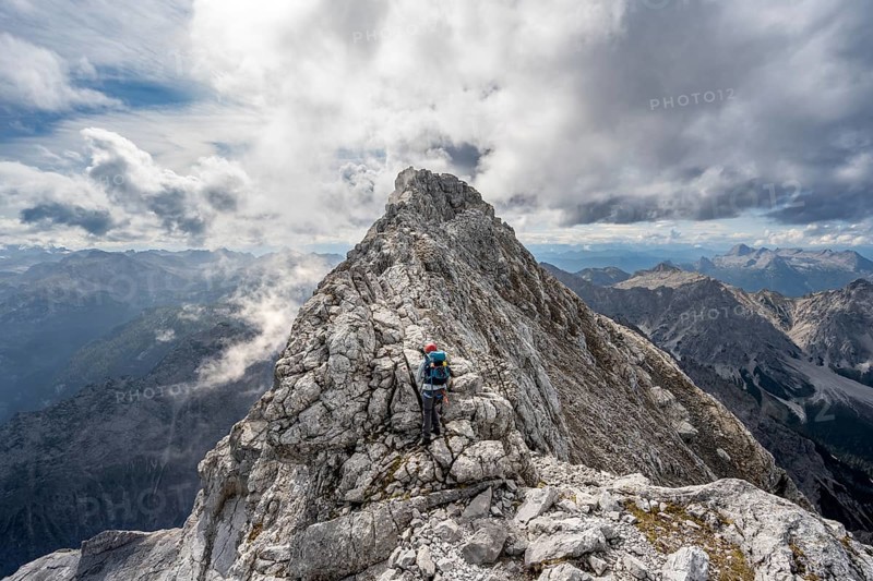 Mountaineer on a narrow rocky ridge