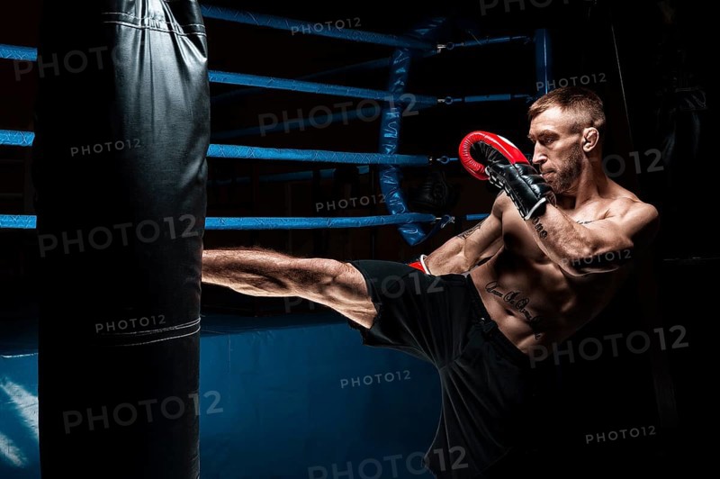 Kickboxer kicks the bag. Training a professional athlete. The concept of mma