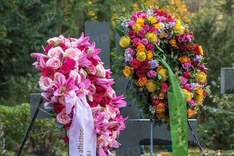 Funeral wreath with flowers at a grave