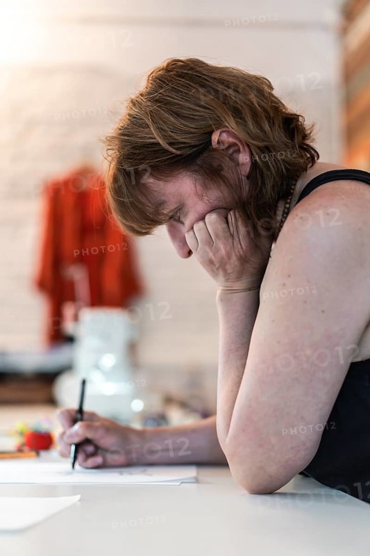 Side view of a fashion desinger creating new designs