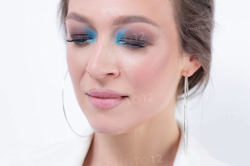 Portrait of a beautiful girl with a defiant make-up. White background. Beauty concept. High quality