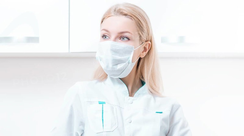 Portrait of a blonde girl in a mask. Coronavirus epidemic concept. Pandemic.