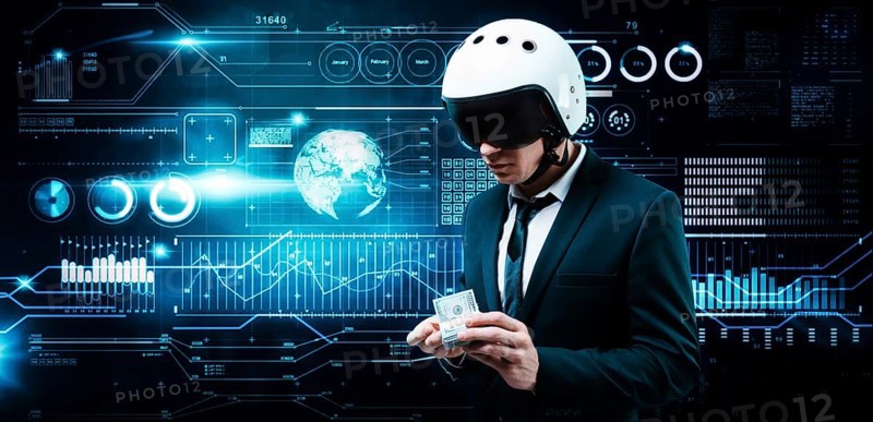 Portrait of a businessman in a suit and aviator helmet. He holds a bundle of hundred-dollar bills in front of him. Business concept.