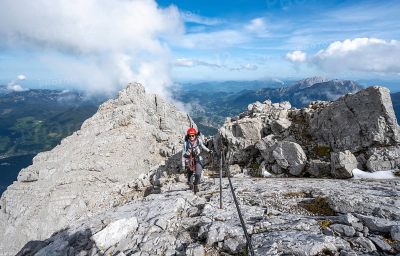 Climber on a via ferrata secured with a steel cable