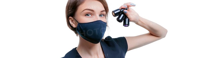 Portrait of an elegant beautiful girl with a set of nail polishes in her hand. Advertising banner for beauty salons during Covid-19. Pandemic. Modern trends