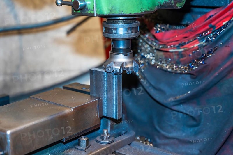 The CNC milling machine cuts the metal parts with a milling machine tool. Numerical control workshop