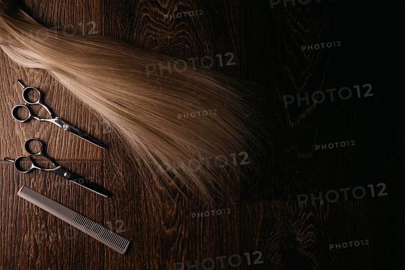 Natural hair of different colors with scissors and comb. concept of hair care and hairdressing services