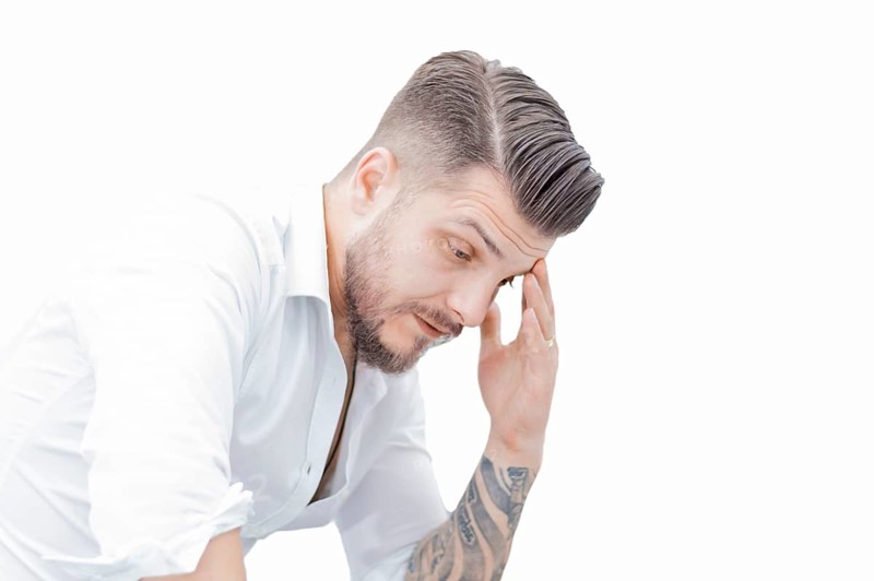 Man in a shirt is upset by an unsuccessful sports bet.