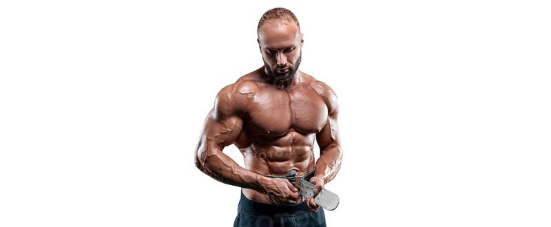 Athlete posing with an athletic belt on a white background. Fitness