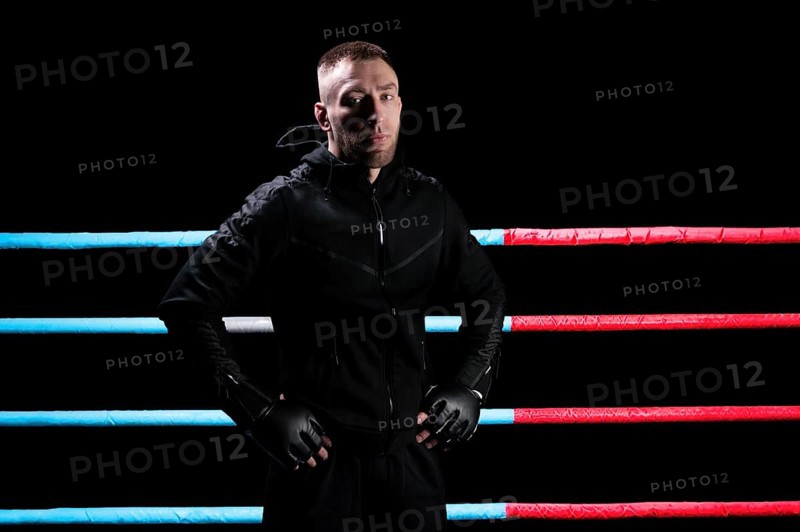 Mixed martial artist posing in boxing ring. Concept of mma