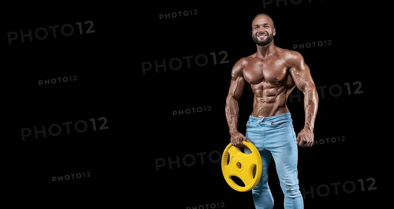 Isolated muscular man on a black background. Bodybuilding and fitness concept. Panorama.