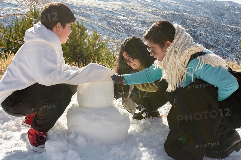 Snowy Escapades A Heartwarming Latino Family Building Snowman Memories in Sierra Nevada