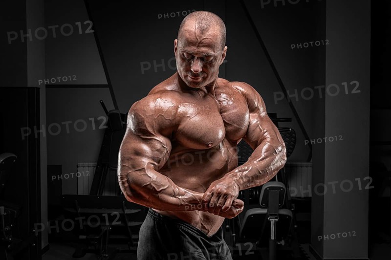 Professional weightlifter posing in the gym. Classic bodybuilding.