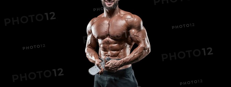 No name sexy muscular man in jeans posing on black background with a belt. Bodybuilding and fitness concept.