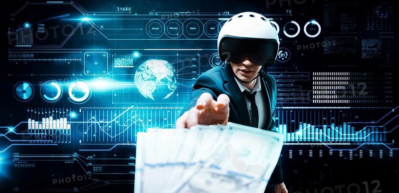 Portrait of a businessman in a suit and aviator helmet. He is trying to reach a pack of hundred-dollar bills. Business concept.