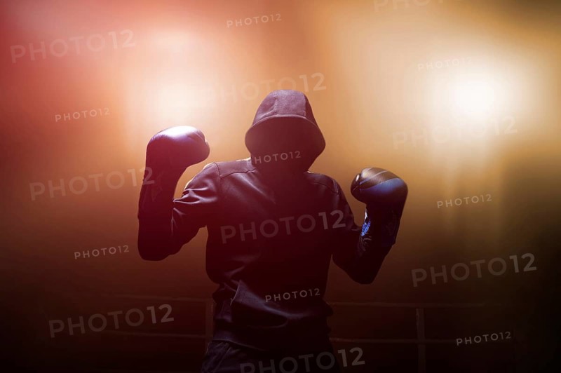 Fighter without a face is standing with his hands up. The concept of boxing