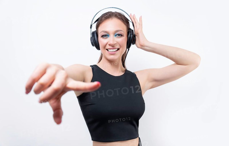 Portrait of a woman in professional headphones. White background. Dj concept.