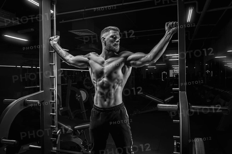 Portrait of an athlete in a special ramp in the gym. Bodybuilding and fitness concept.