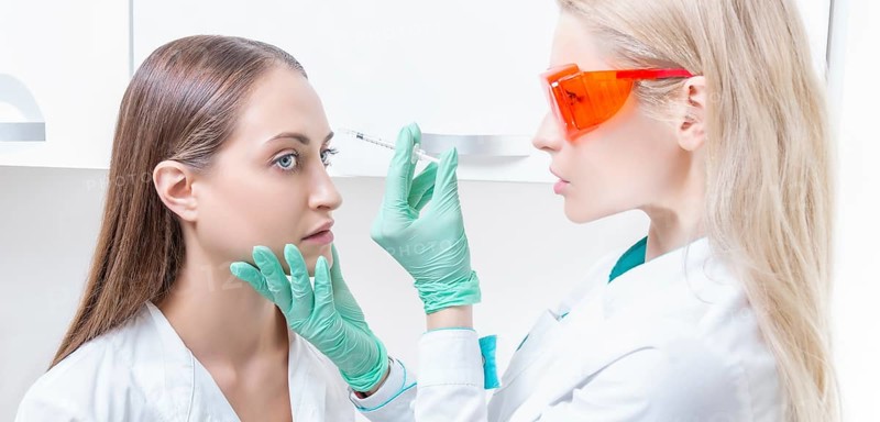 Portrait of two girls in white coats. The concept of cosmetology