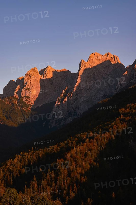 The last rays of sunlight illuminate the peaks of the Wilder Kaiser