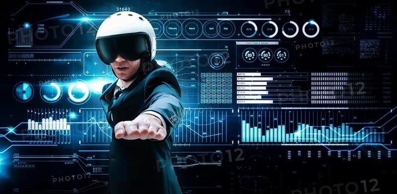 Portrait of a man in a suit and helmet. He shows that he is flying against the background of a futuristic hologram. Business concept. Internet technologies.