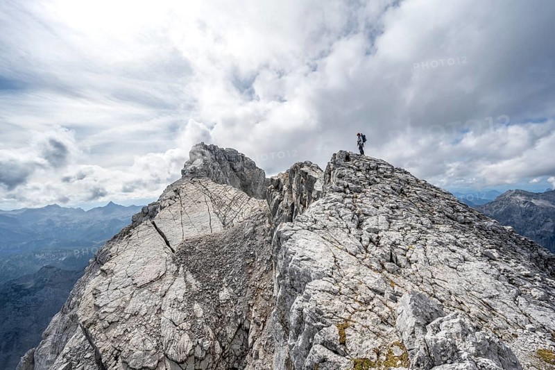 Mountaineer on a narrow rocky ridge