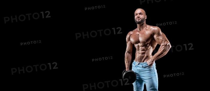 Isolated muscular man on a black background. Bodybuilding and fitness concept. Panorama.