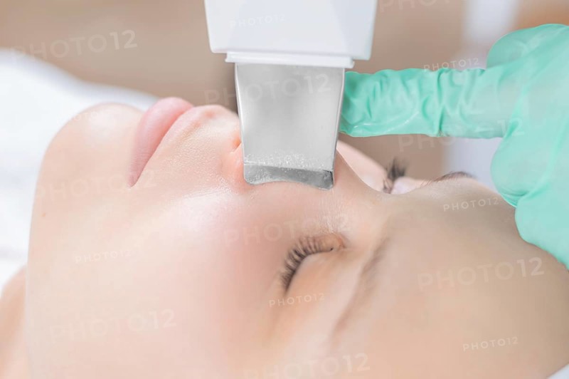Young pretty woman receiving treatments in beauty salons. Ultrasonic cleaning procedure. Hardware cosmetology.