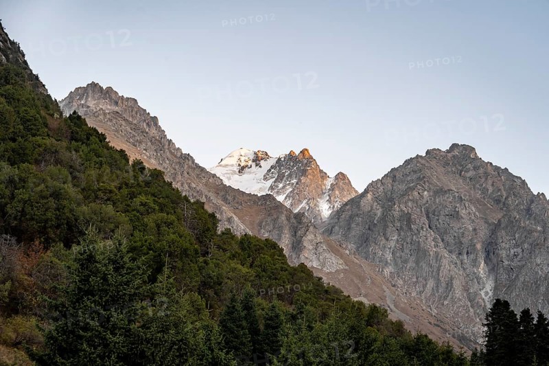 Glaciated mountain peak at sunset