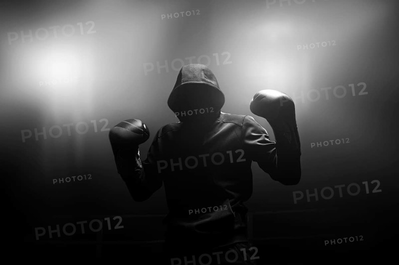 Fighter without a face is standing with his hands up. The concept of boxing
