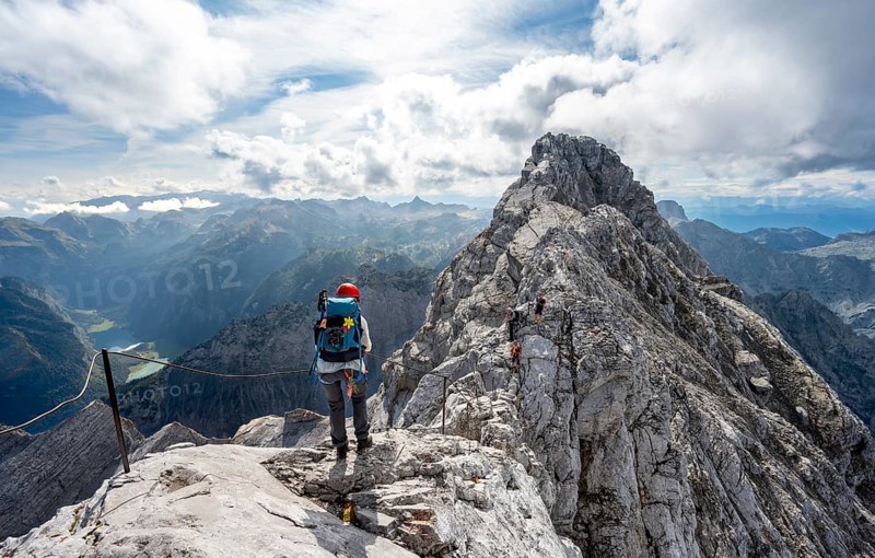 Climber on a via ferrata secured with steel rope