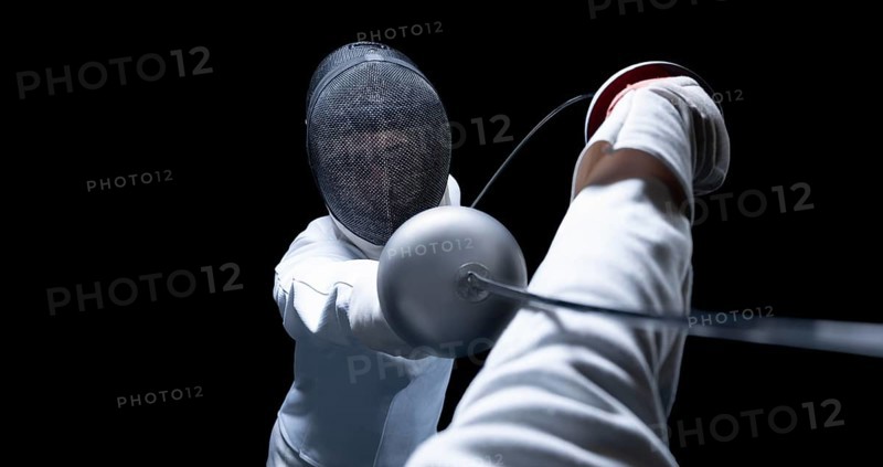 Two fencers are fighting in a tournament. The concept of fencing.