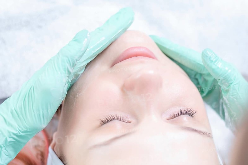 Beautiful girl gets face peeling. Skin health concept. Beauty salons.