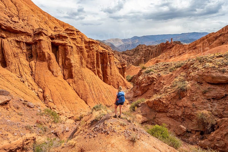Climber in a canyon with a dry stream bed