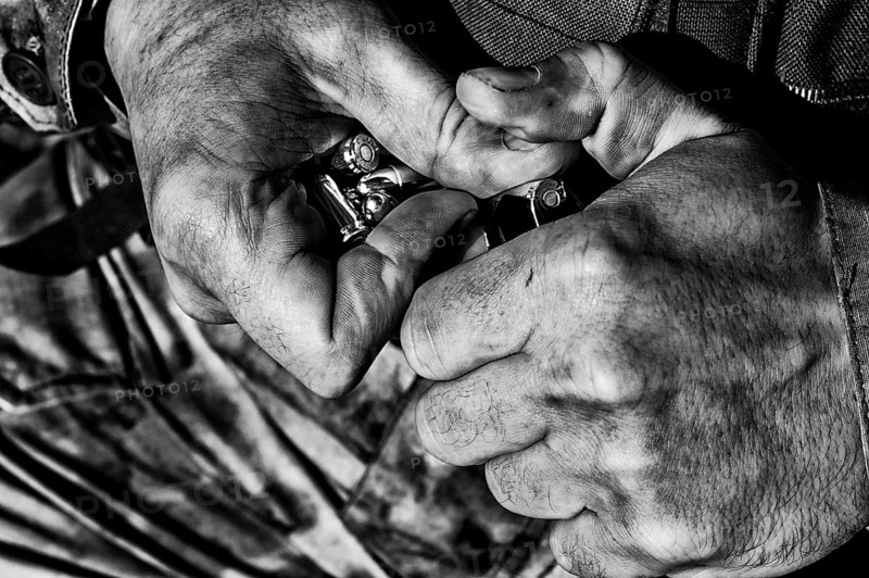 The fighter prepares a clip with bullets before the next fight.