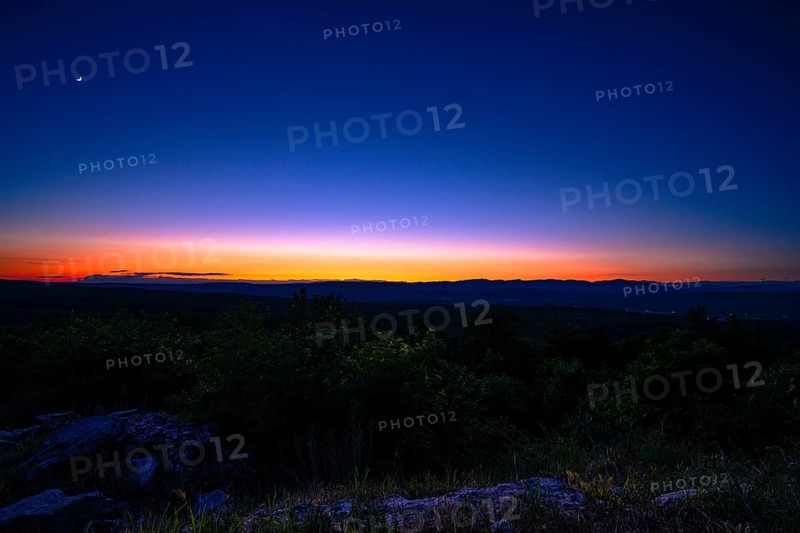 Sun sets behind the Catskills Mountains