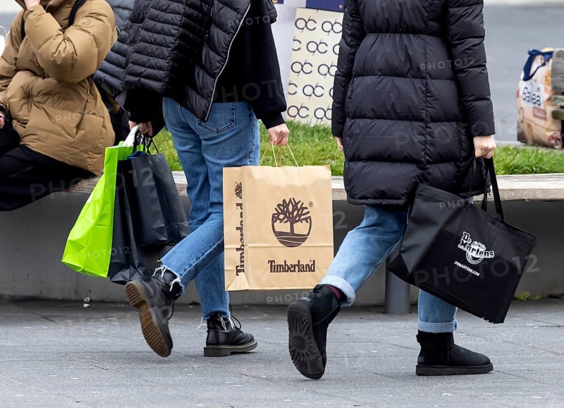 Consumer tourist lugging shopping bags