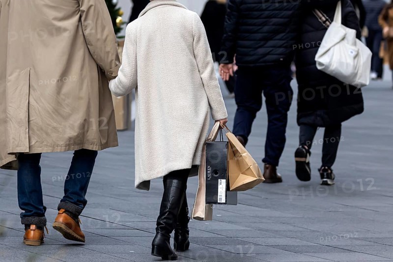 Consumer tourist lugging shopping bags