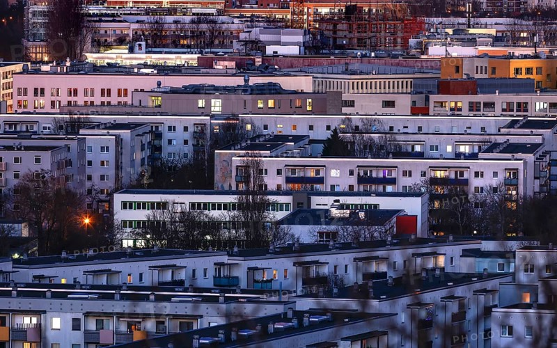 View in the evening at blue hour of high-rise buildings and apartment blocks with rental flats and condominiums in the Berlin district of Marzahn-Hellersdorf