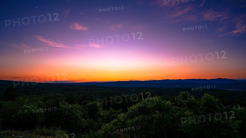 Sun sets behind the Catskills Mountains